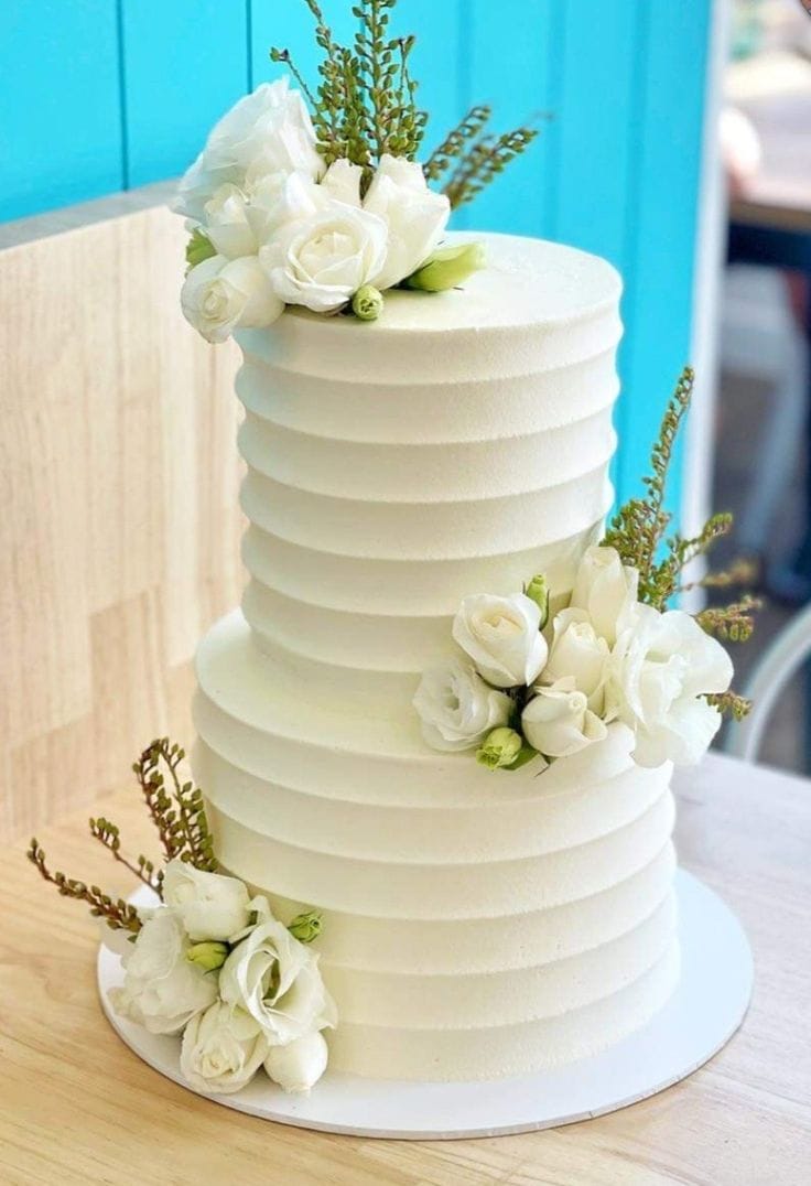 💍 Classic White Floral Two-Tier Cake – Elegant Wedding Cake